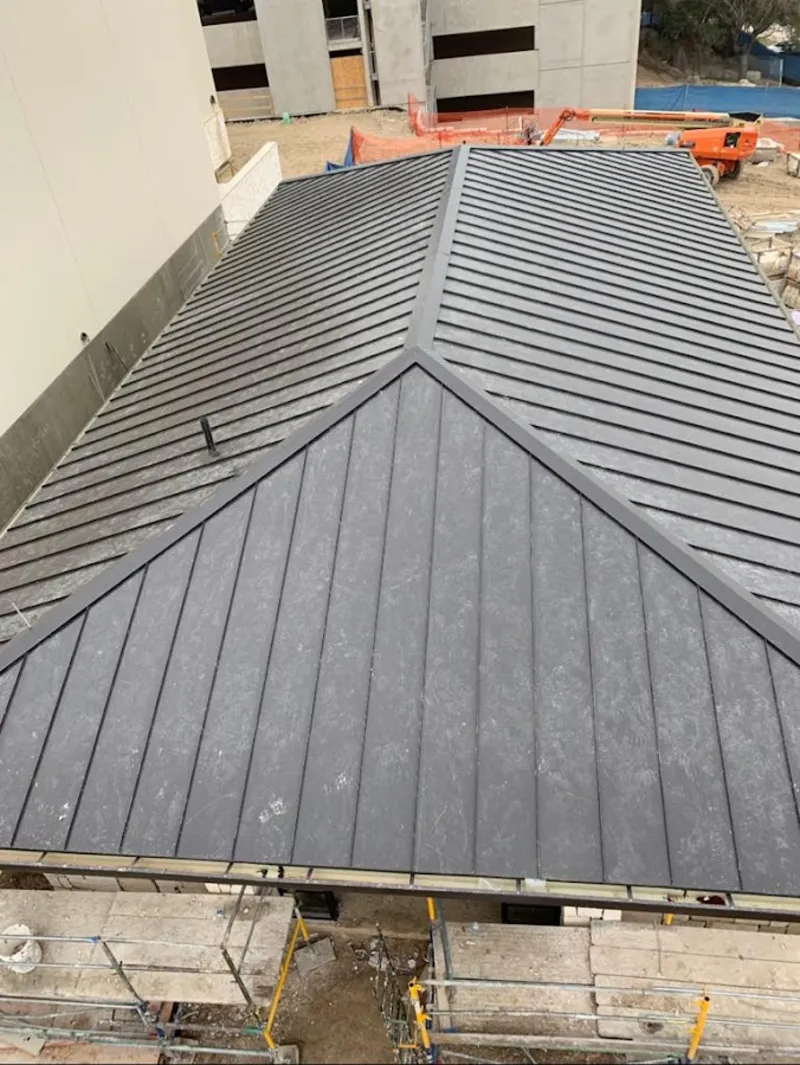 Commercial metal roof construction with crane equipment in Harriman