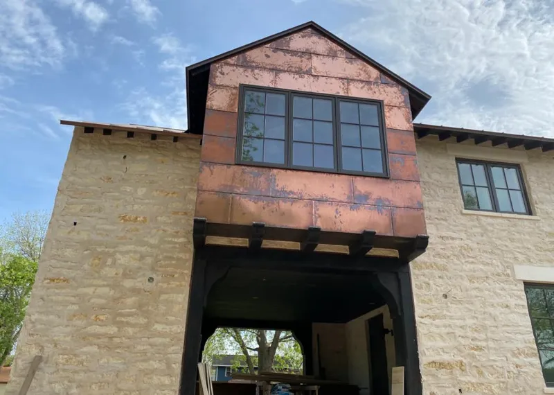 Copper metal panel facade on a stone building for Skylight Installation in Harriman